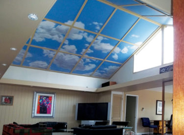 Vaulted living room ceiling with trompe l’oeil mural