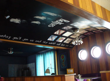 Arched ceiling with trompe l’oeil mural with custom stenciling