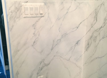 White Carrara marbling in master bath