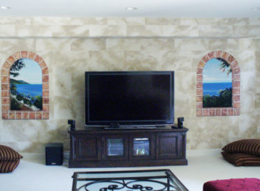 Family room with faux stone and trompe l’oeil mural