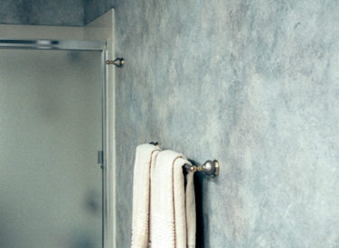 Guest bath in dramatic olde-world multi-color and textured faux finish